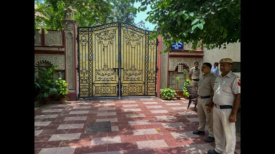 Police personnel outside a property linked to Haryana MLA Gopal Kanda during an Enforcement Directorate (ED) raid as part of a money laundering investigation, in Gurugram on Wednesday. (PTI)